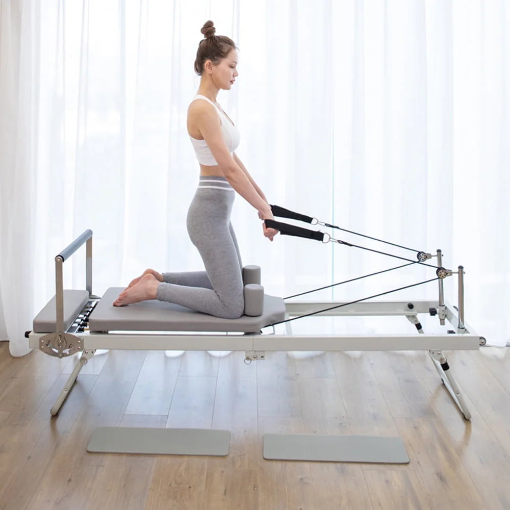 ARKANTOS foldable home Pilates reformer machine with resistance cords and wheels